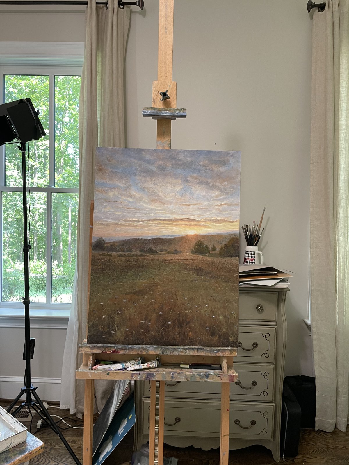 A landscape in progress on the easel in Kathy Wood's studio