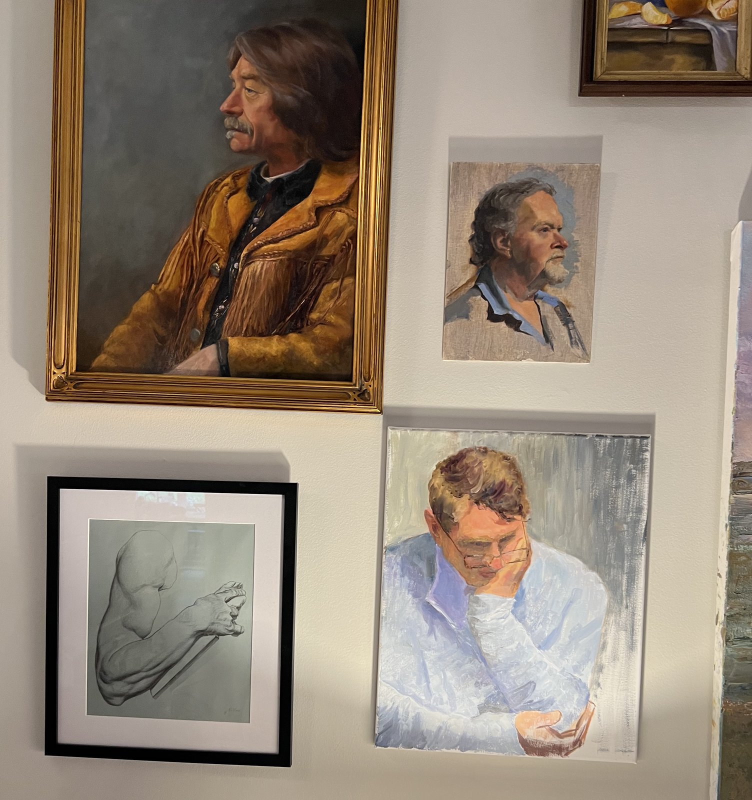 Several of Kathy Wood's paintings and drawings hung together on a wall